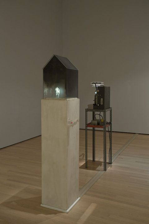 Home, 1986, Glass, lamp back, painted wood, projector, metal support, and 16mm black and white film, loop, mute, 1 min 10 s.